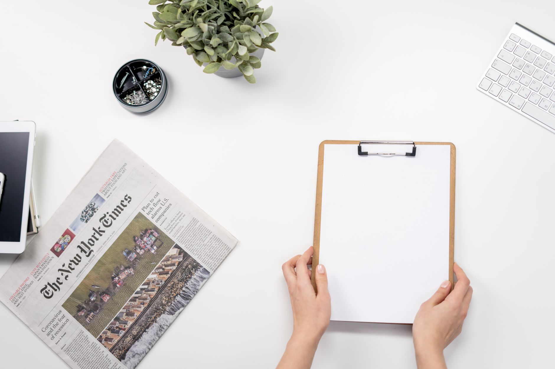 Flat lay of a home office desk with a clipboard, newspaper, and accessories. — UnionRayo: The Digital Home for Rayo Vallecano
