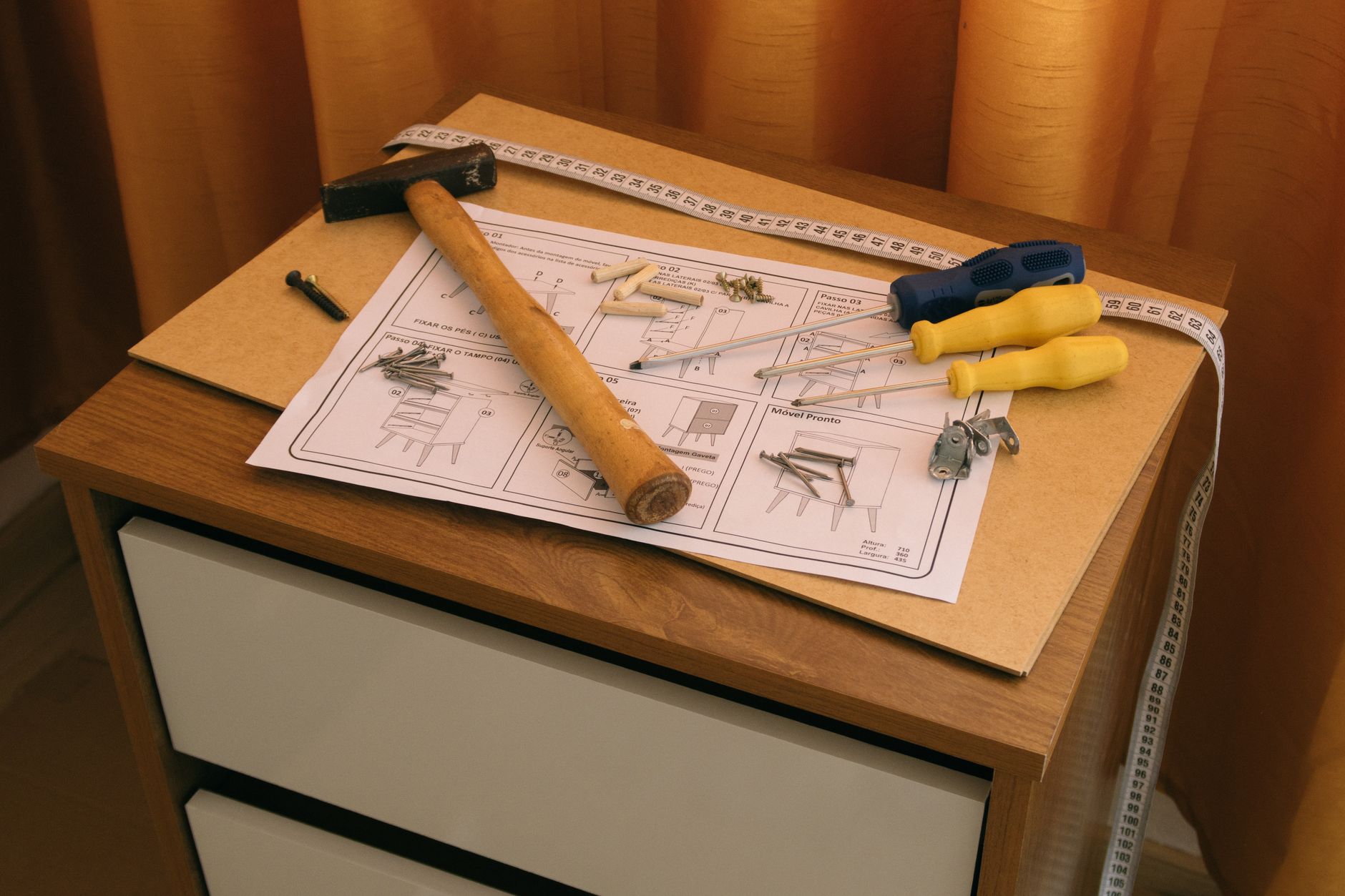 From above of wooden cabinet with drawers and paper instruction with tool to assemble it — "Window Installation Doral: Expert